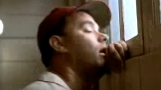 Tom Hanks puts his face against the wall while he's peeing.