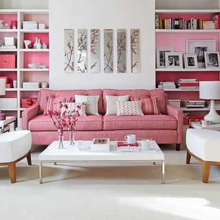 pink and white living room with alcove shelving