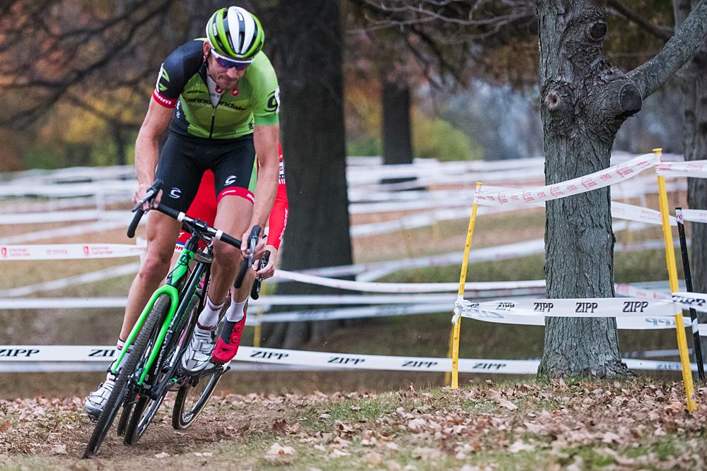 Ryan Trebon (Cannondale pb Cyclocrossworld) standing on his pedals while accelerating out of a turn in pursuit of Jermey Powers.