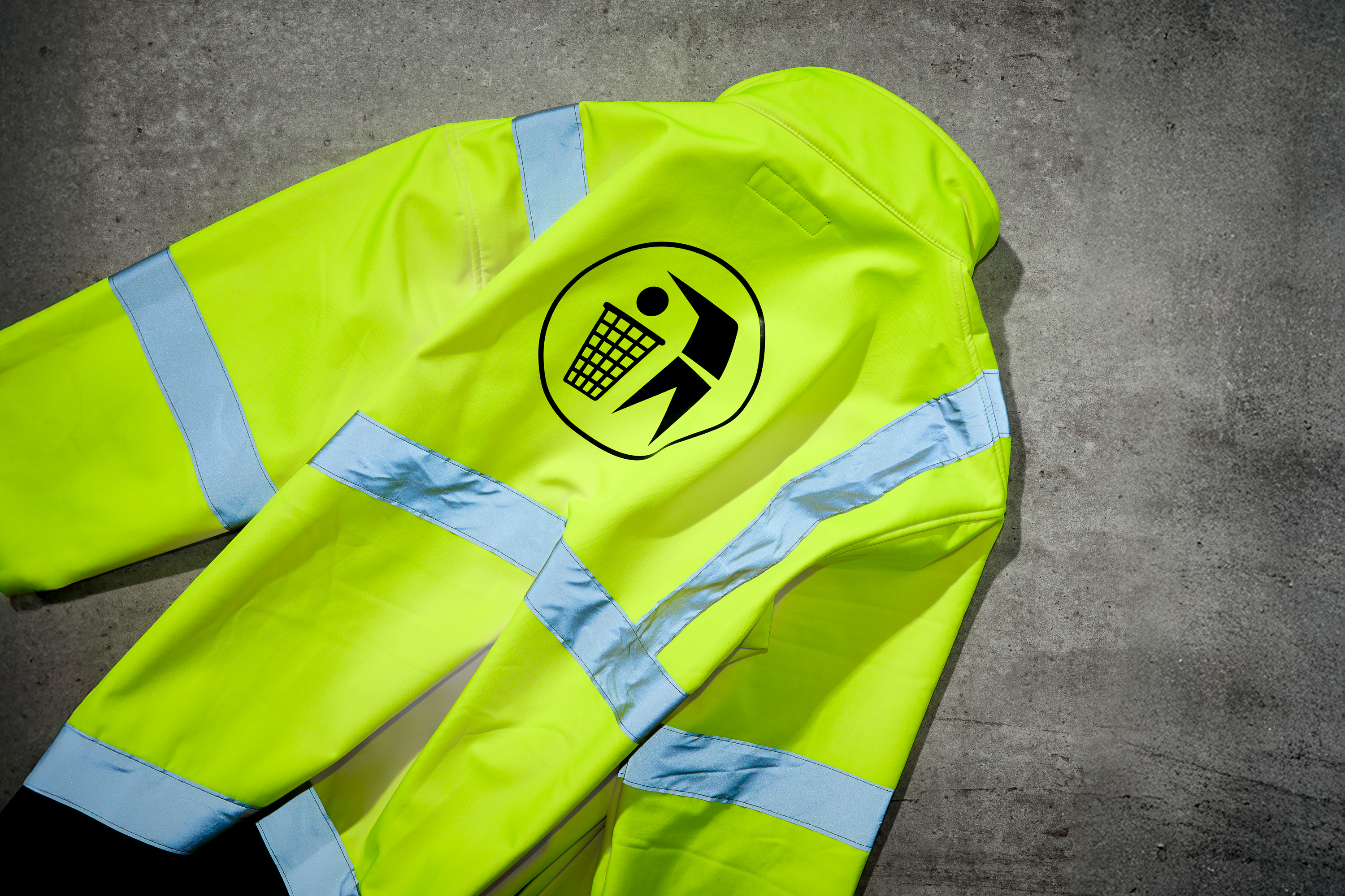 yellow fluorescent jacket with symbol for someone throwing something in the bin on it