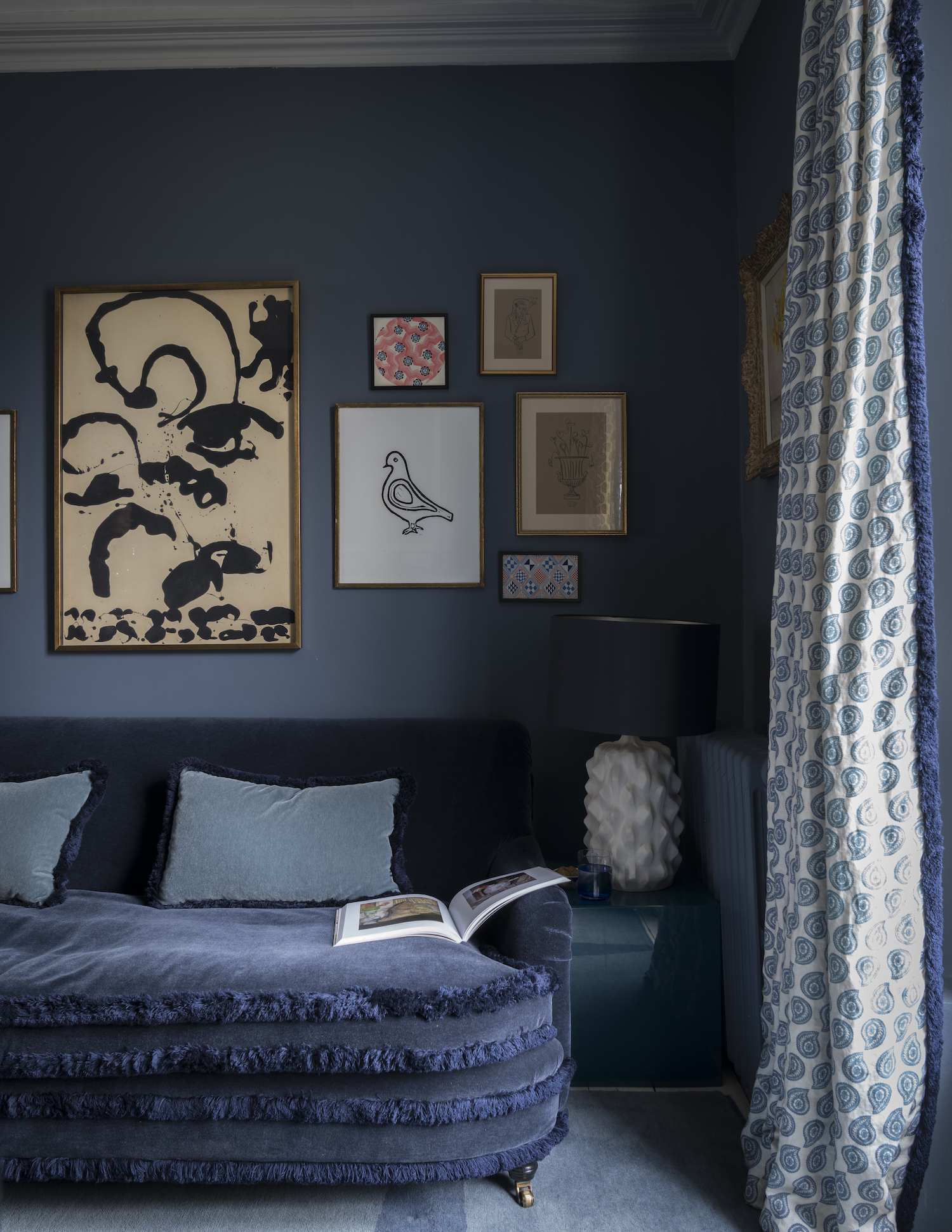 blue living room with fringed curtains