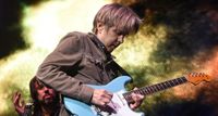 Texan guitar phenom Eric Johnson plays a Fender Stratocaster in a Tropical Turquoise finish during a 2016 performance with the Experience Hendrix Tour.