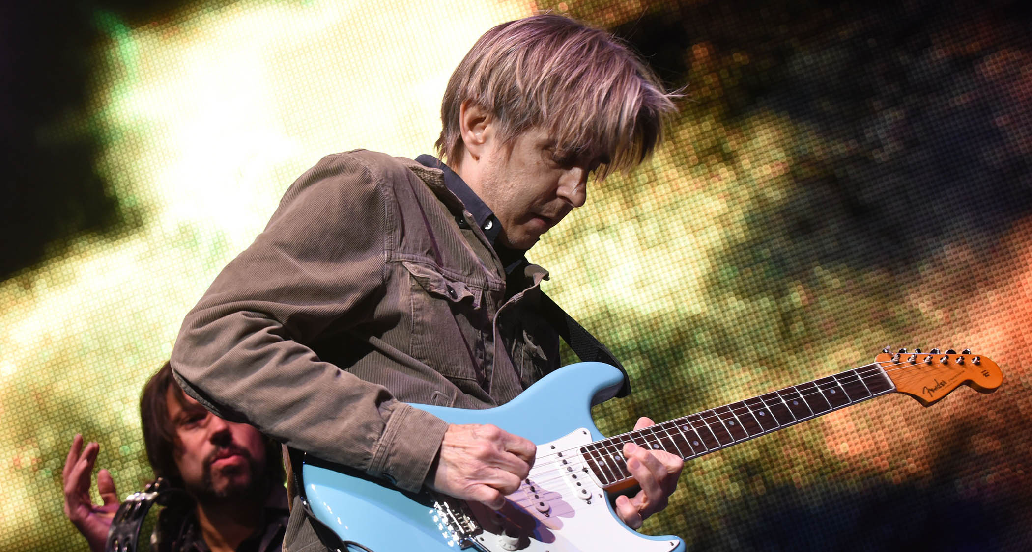 Texan guitar phenom Eric Johnson plays a Fender Stratocaster in a Tropical Turquoise finish during a 2016 performance with the Experience Hendrix Tour.