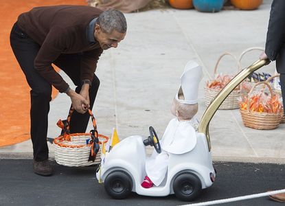 President Obama greets a trick-or-treater at the White House