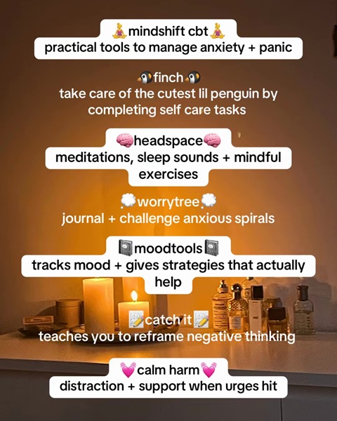 A candlelit side table with various self care products on, along with text information on mental health support apps.