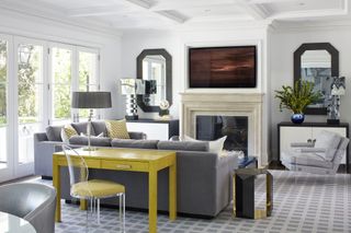 Grey living room with yellow console table and cushions