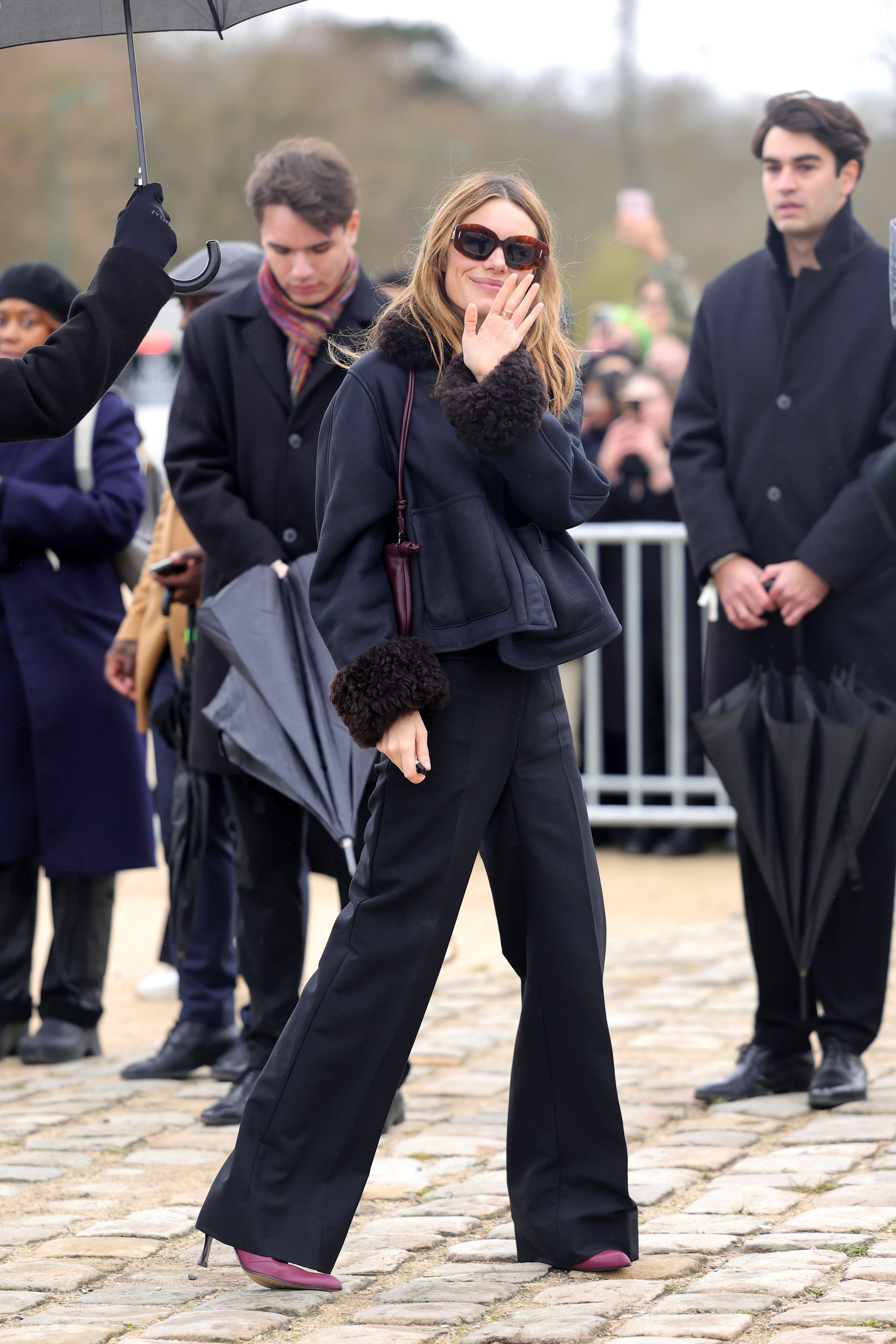 Camille Rowe wears wide-leg pants
