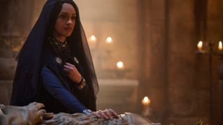 Queen Regent Míriel (Cynthia Addai-Robinson) rests her hand on a tomb in "The Rings of Power" season 2