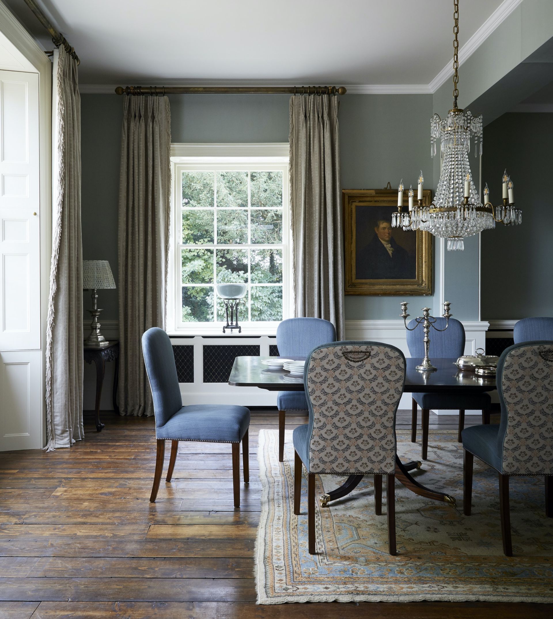 Blue/grey wallpaper with white linings, window frames and shutters