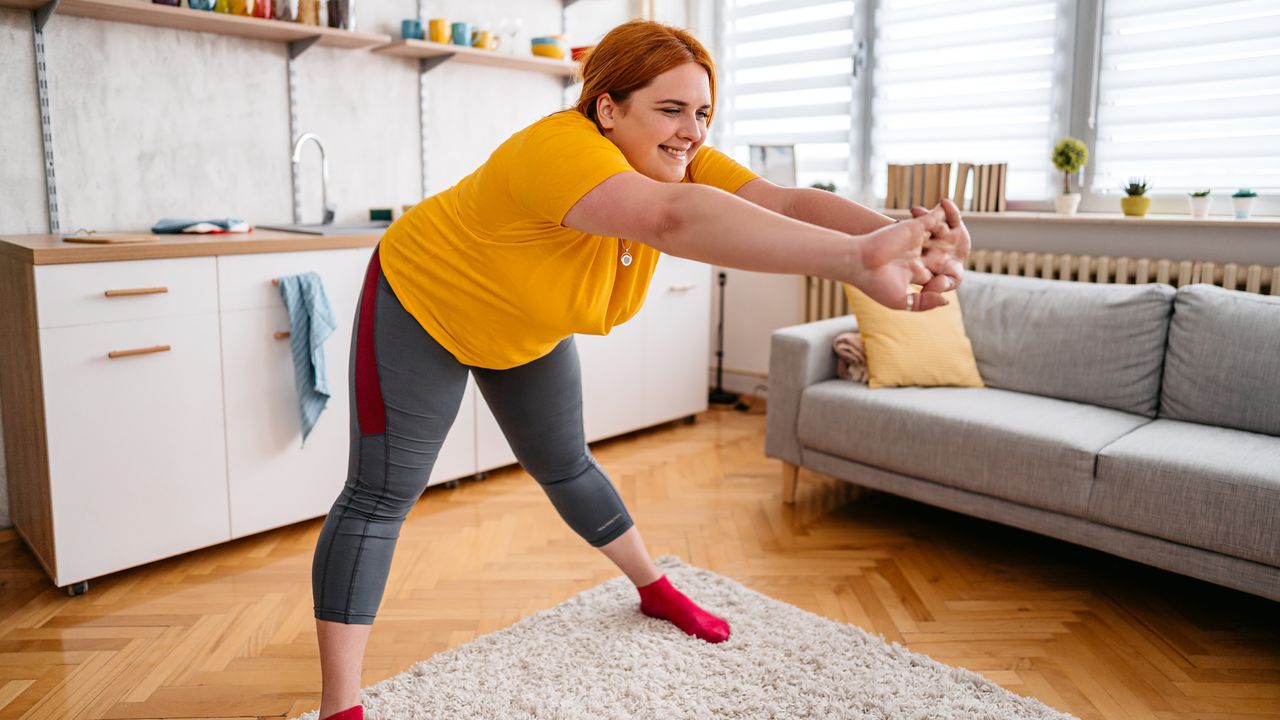 Woman stretches in domestic setting