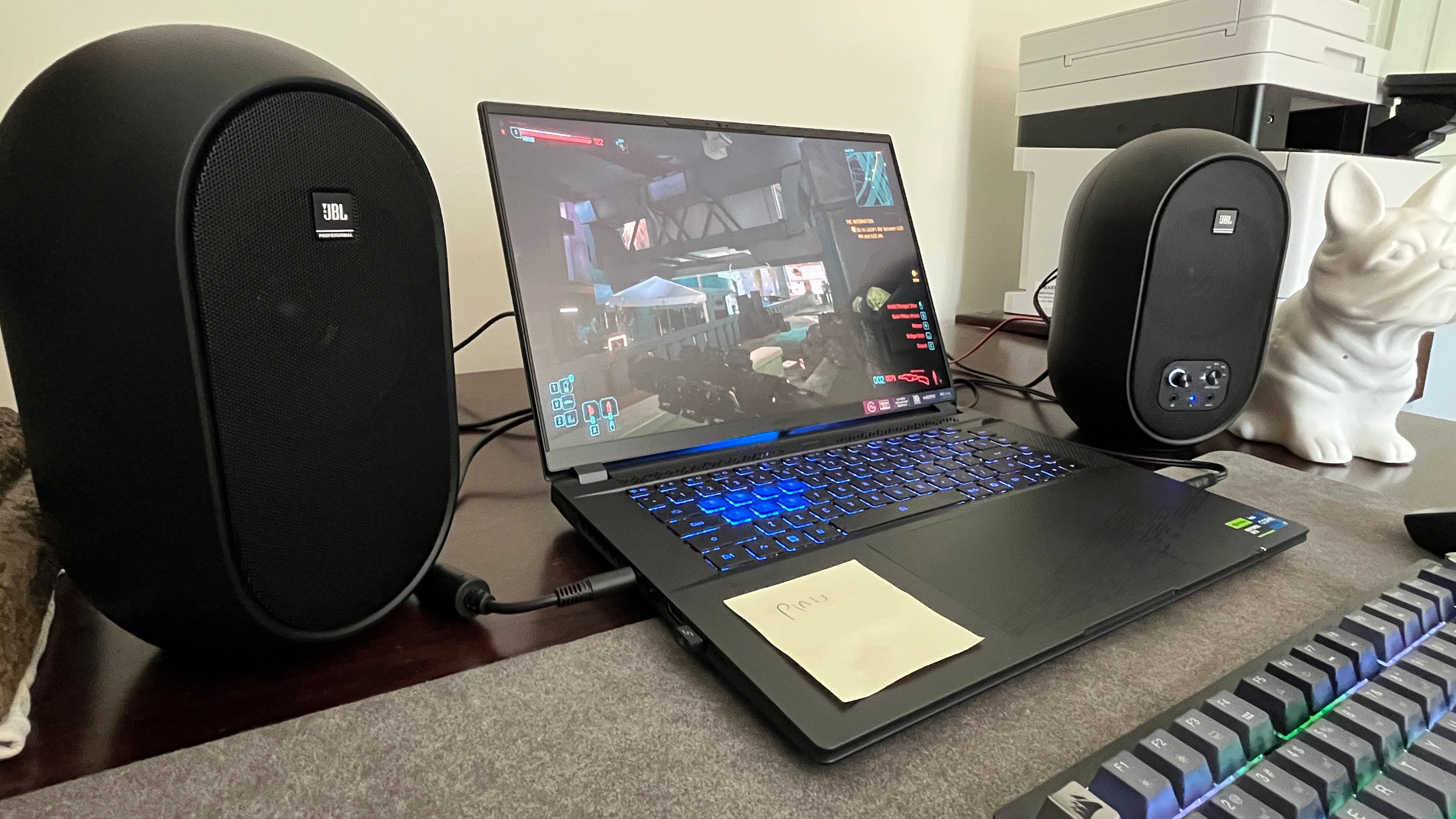 JBL 104-BT speakers next to a gaming laptop on a desk