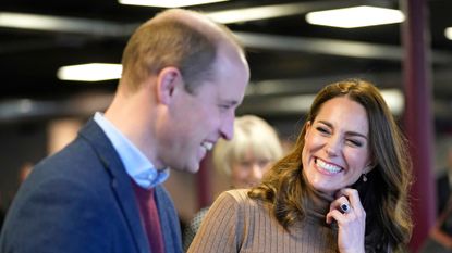 Prince William and Kate Middleton laugh together as they visit a church in burnley