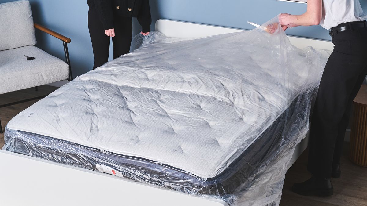 Two mattress testers unboxing a memory foam mattress to test its off-gassing