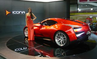 Red Icona Volcano on display at a car show with a model in a red dress