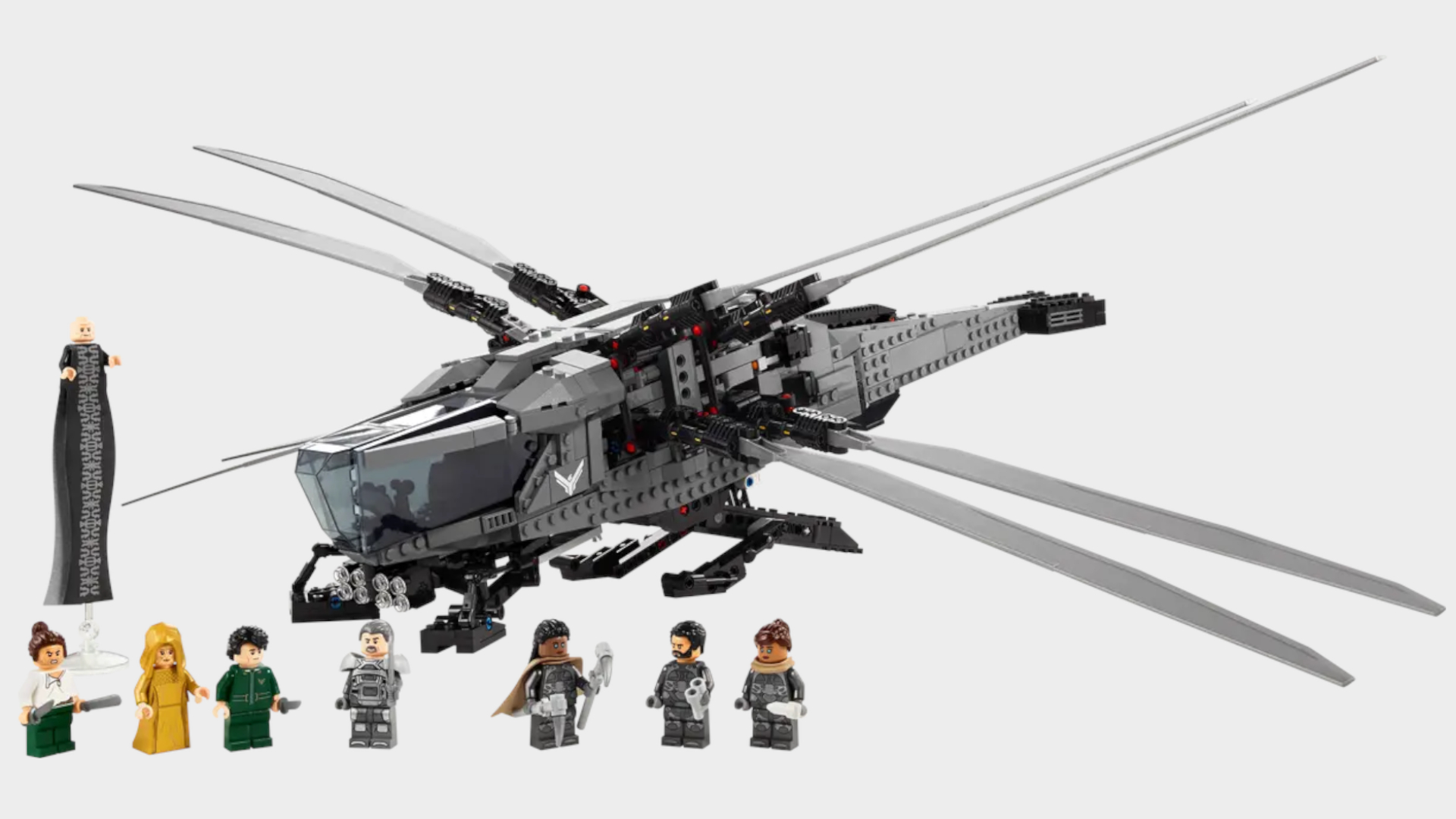 Lego Dune Ornithopter kit and minifigures on a plain background