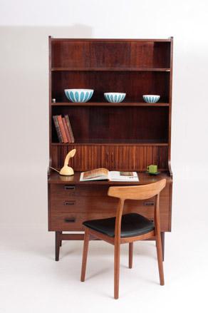 A brown wooden high-board displaying blue and white bowls.