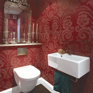 Red cloakroom with damask wallpaper