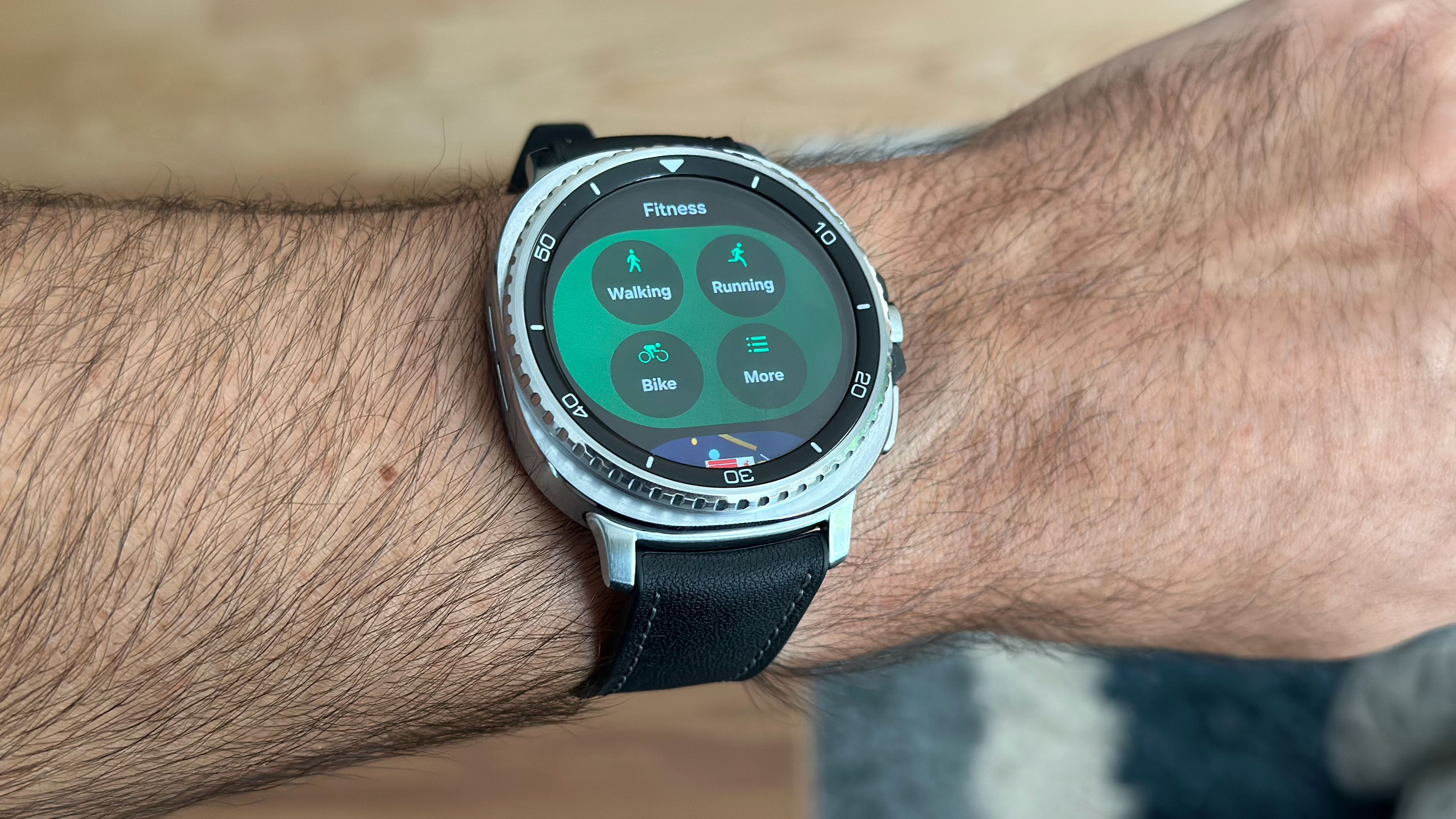 The Fitness Tile on the Samsung Galaxy Watch 8 Classic showing four workout options.