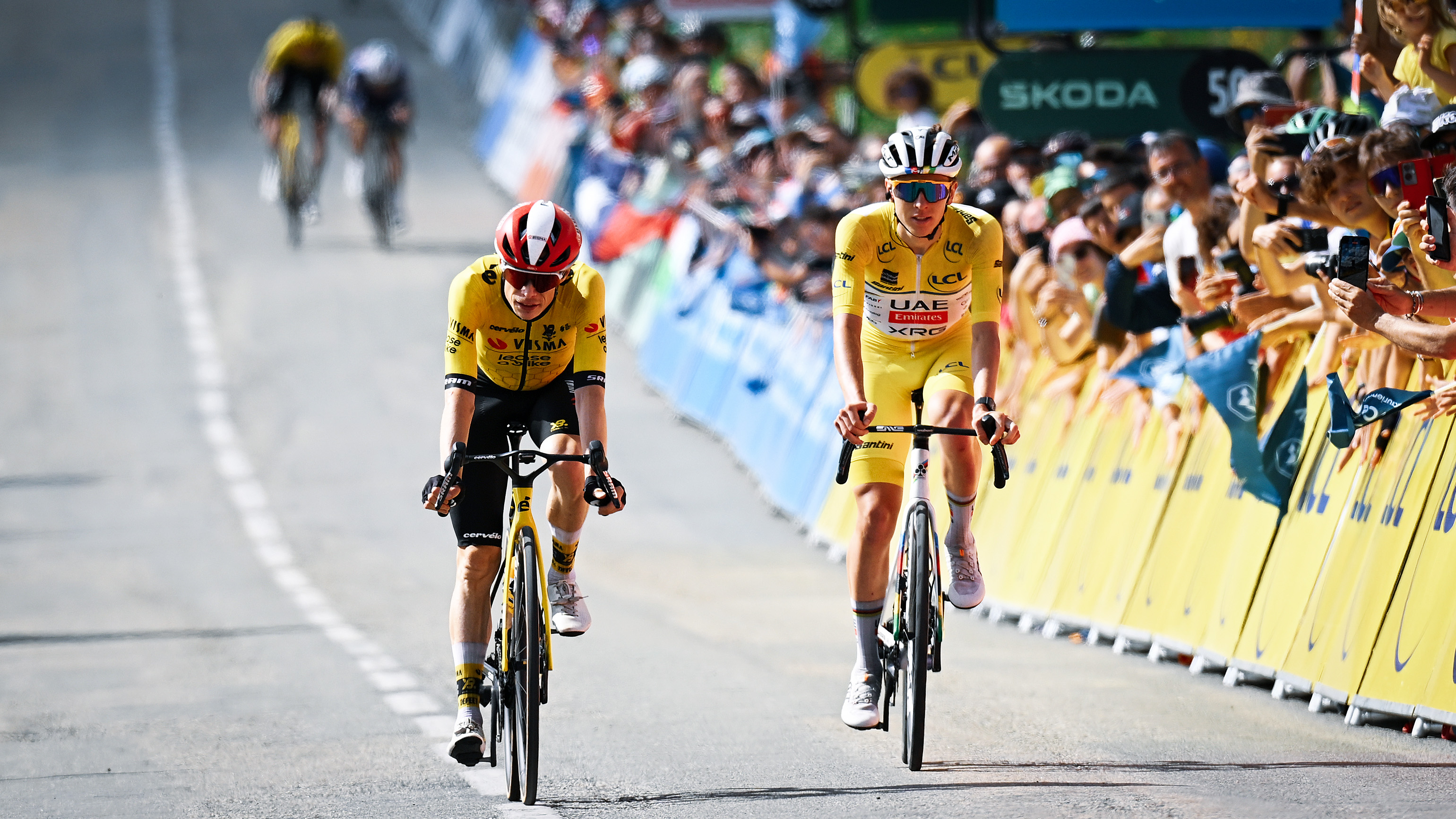 CENIS, FRANCE - JUNE 15: (L-R) Jonas Vingegaard of Denmark and Team Visma | Lease a Bike and Tadej Pogacar of Slovenia and UAE Team Emirates - XRG - Yellow leader jersey crosses the finish line during the 77th Criterium du Dauphine 2025, Stage 8 a 133.3km stage from Val-d'Arc to Plateau du Mont-Cenis 2095m / #UCIWT / on June 15, 2025 in Plateau du Mont-Cenis, France. (Photo by Dario Belingheri/Getty Images)