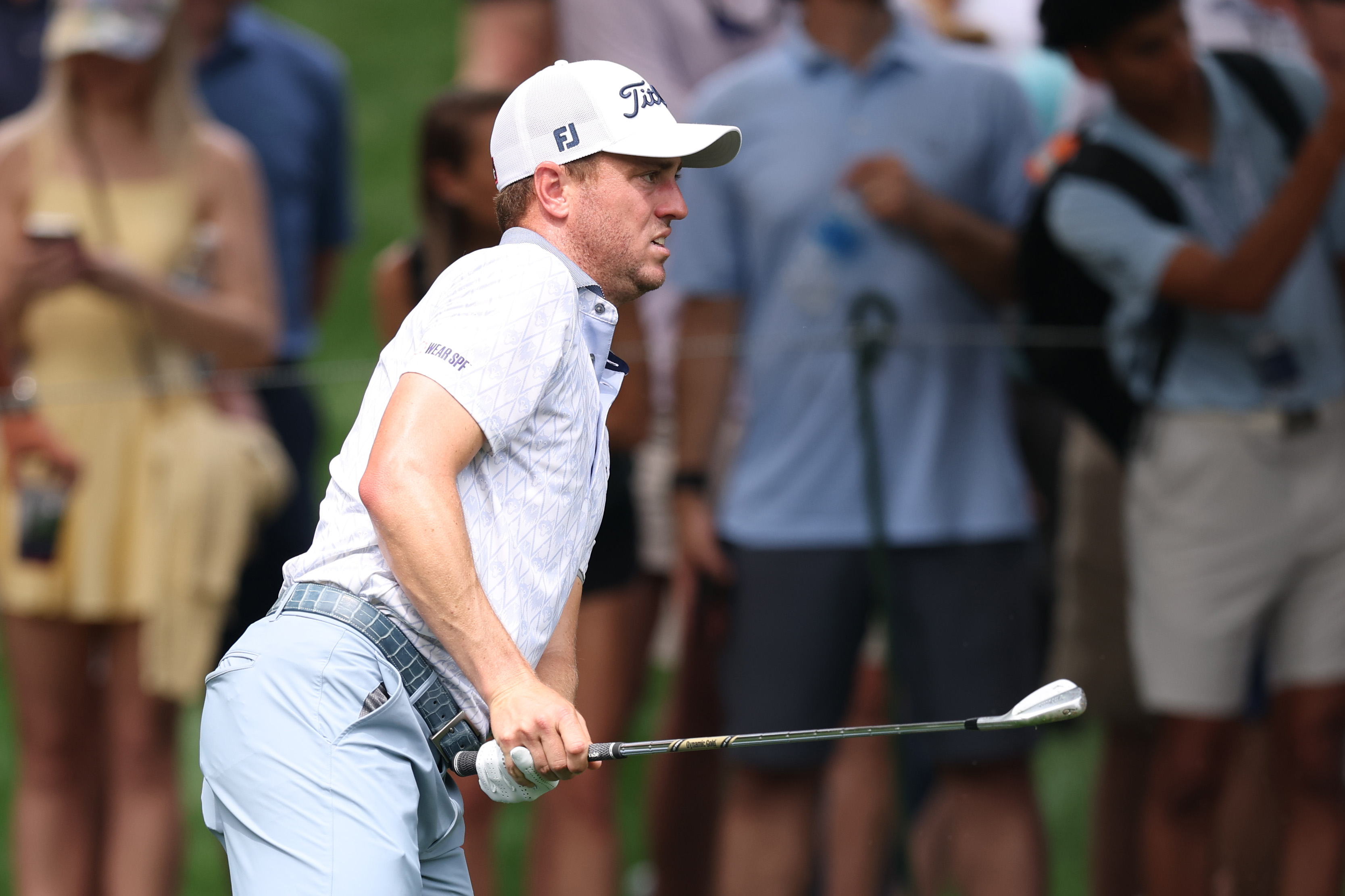 Justin Thomas watches an iron shot