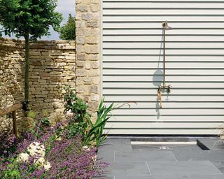 outdoor shower with paving from mandarin stone