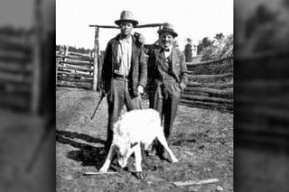 Federal hunter H.P. Williams (left) and a local rancher stand over the slain Custer Wolf on Oct. 11, 1920.