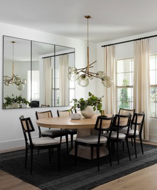 a modern dining table with a large cluster pendant light above it