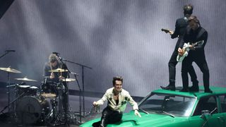 Brandon Urie performs onstage at the 2022 MTV VMAs with Shure microphones.