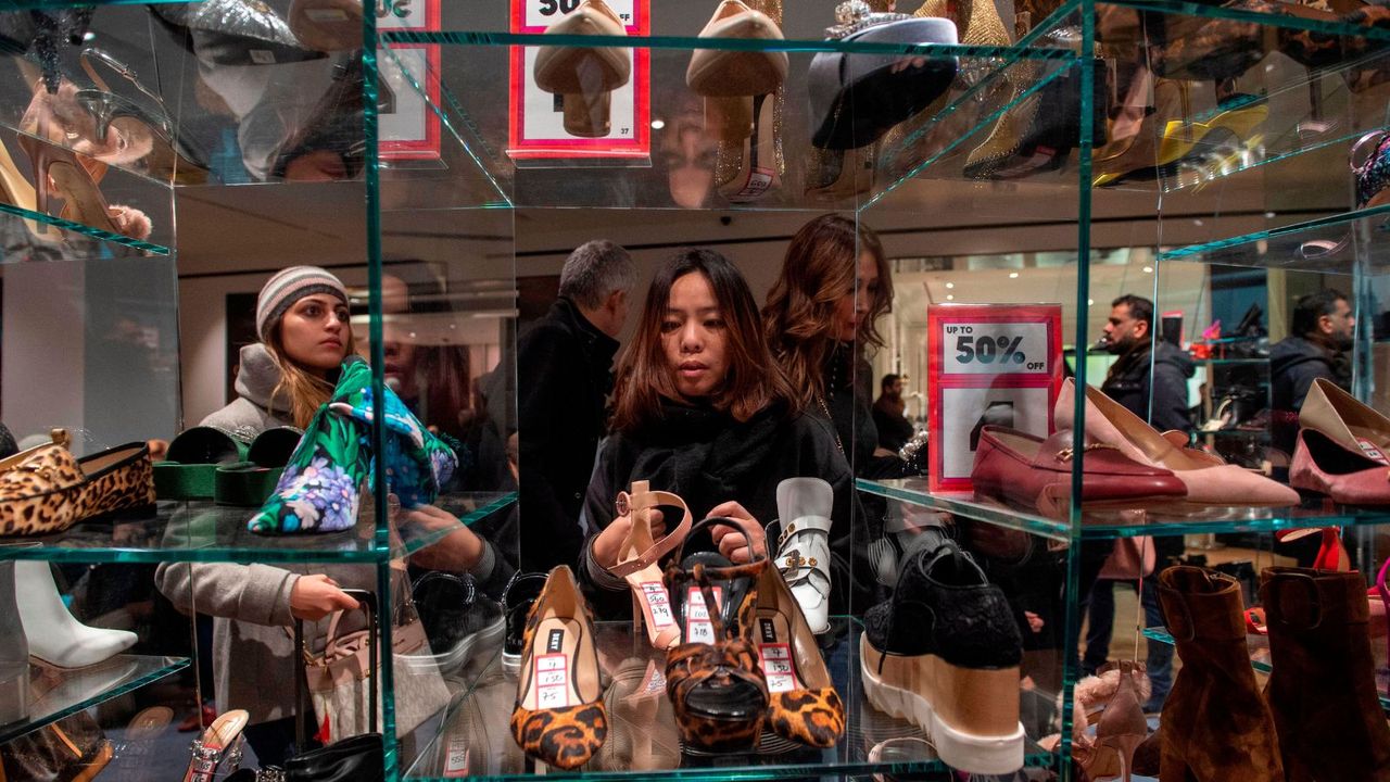 A woman shopping the Boxing Day shoe sale in Selfridges