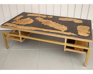 An upcycled coffee table with vinyl stencil detail using brass and gold leaf