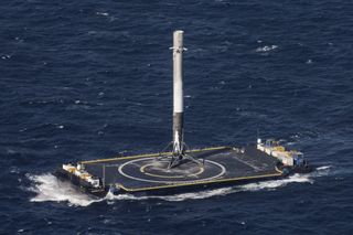 A SpaceX Falcon 9 rocket stands atop the drone ship
