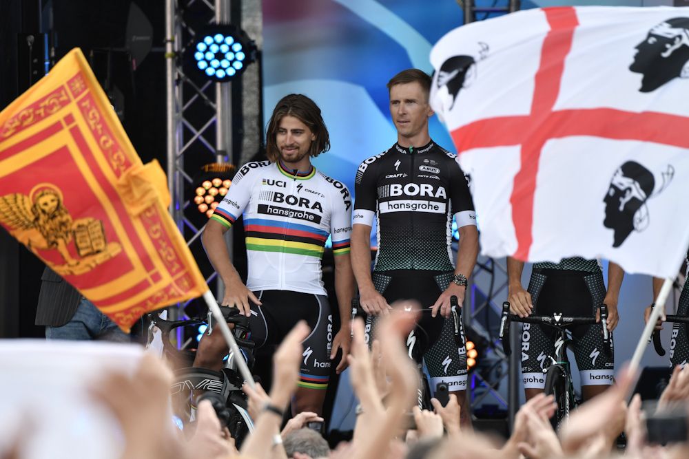 Slovakia's Peter Sagan (L) and Poland's Maciej Bodnar stand on stage during the team presentation ceremony