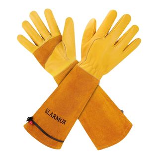 Yellow and orange Slarmor gardening gloves crossed over each other on a white background