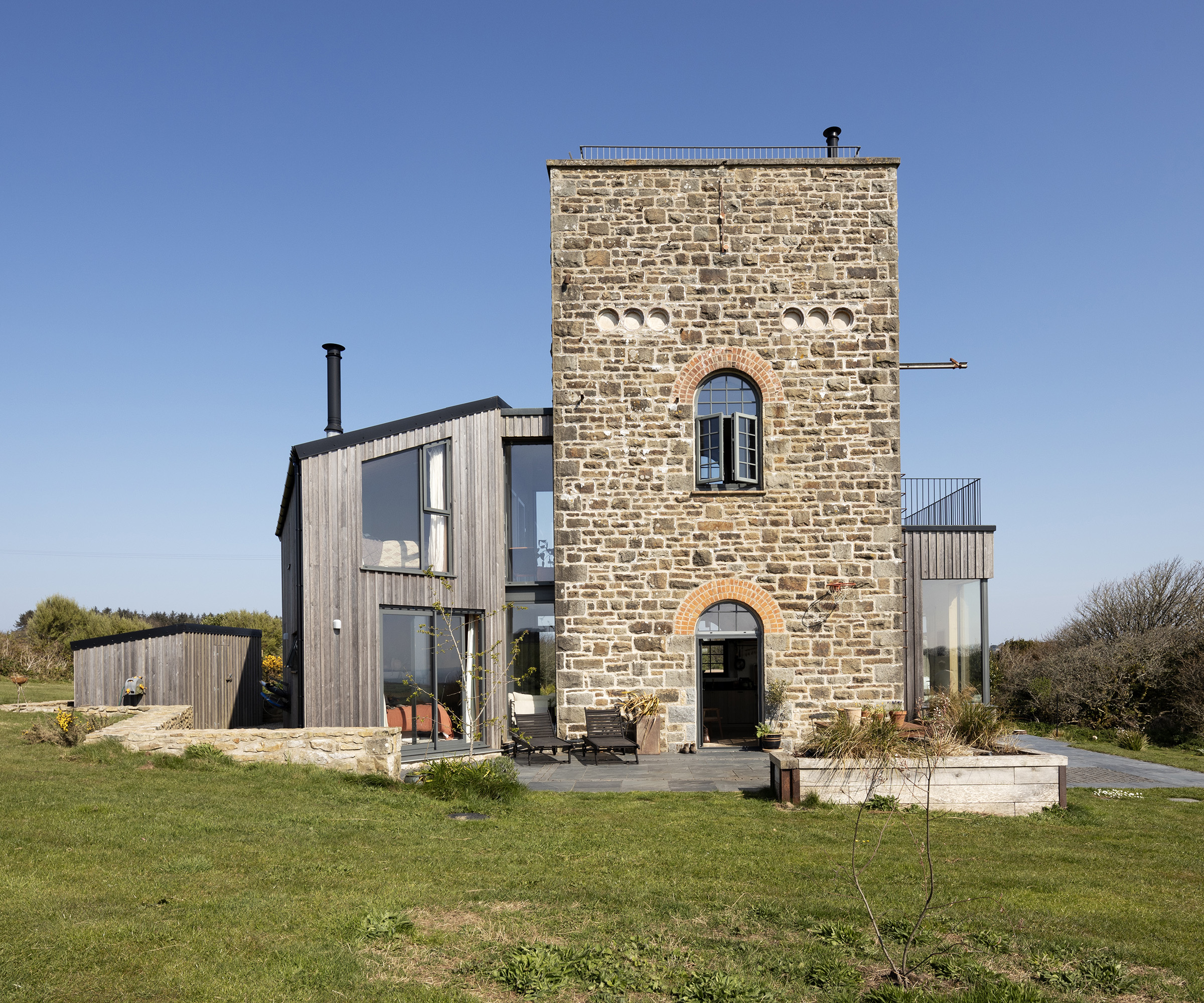 A converted electrical substation with timber clad extensions