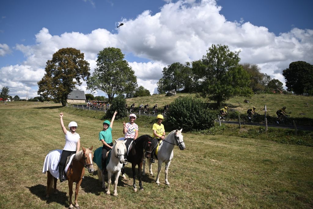 Spectators ride horses as the pack competes in the 13th stage of the 107th edition of the Tour de France cycling race 191 km between ChatelGuyon and Puy Mary on September 11 2020 Photo by Marco BERTORELLO AFP Photo by MARCO BERTORELLOAFP via Getty Images