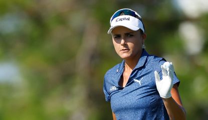 Lexi Thompson waves to the crowd after holing her putt