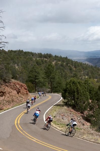 The break descends to the Gila Cliff Dwellings as snow falls in the distance.