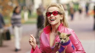 Reese Witherspoon as Elle Woods (dressed in all pink) holding her dog Bruiser in Legally Blonde
