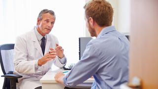 Man receiving news from a doctor.