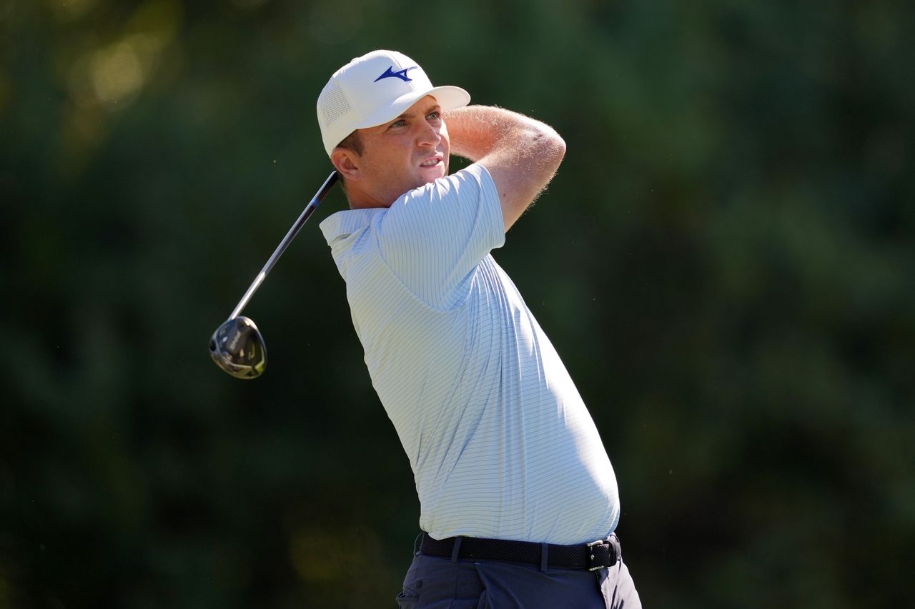 Steven Fisk hits a fairway wood from the fairway