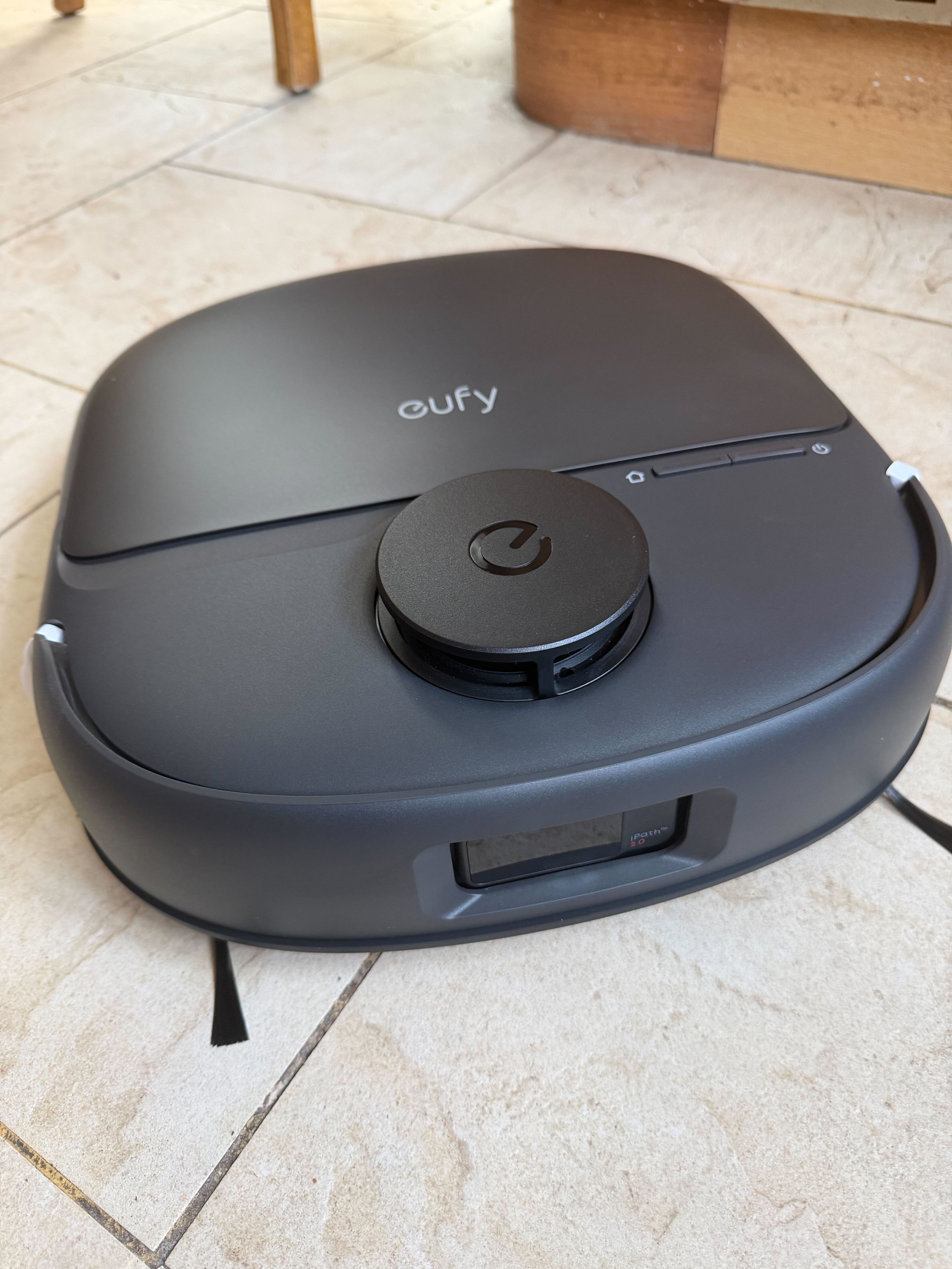 A robovac on stone flooring