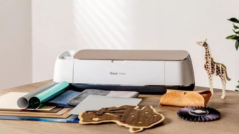 Cricut maker review: a photo of a cutting machine surrounded by craft projects