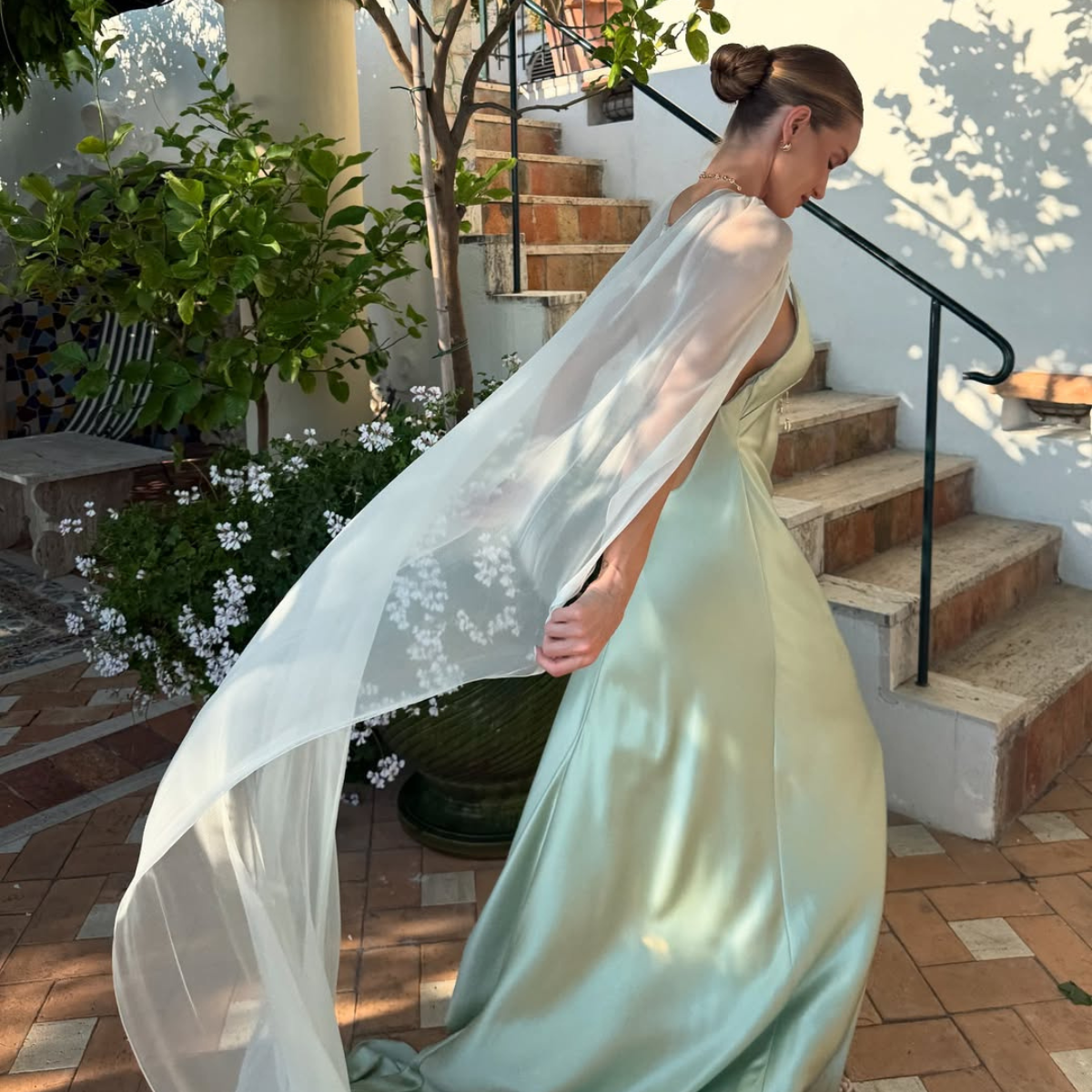 Rosie in a green silk cape dress