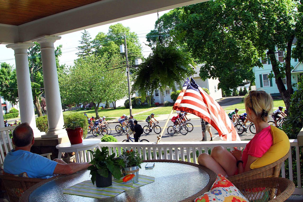 Somerville residents celebrate and remember those fallen as they watch the passing of the peloton.