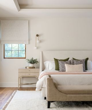 A bedroom with cream walls and furnishings