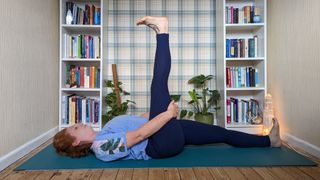 Reclined big toe pose flexibility exercise being performed by Kat Bayly