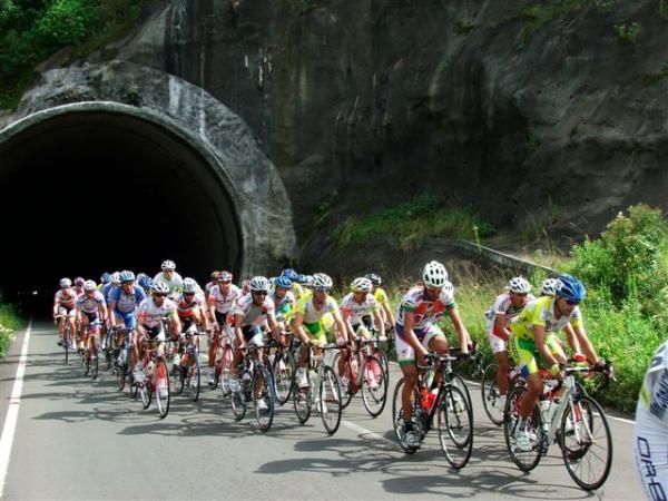 The peloton emerges from a tunnel on stage two