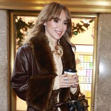 Suki Waterhouse wears a furry brown jacket 