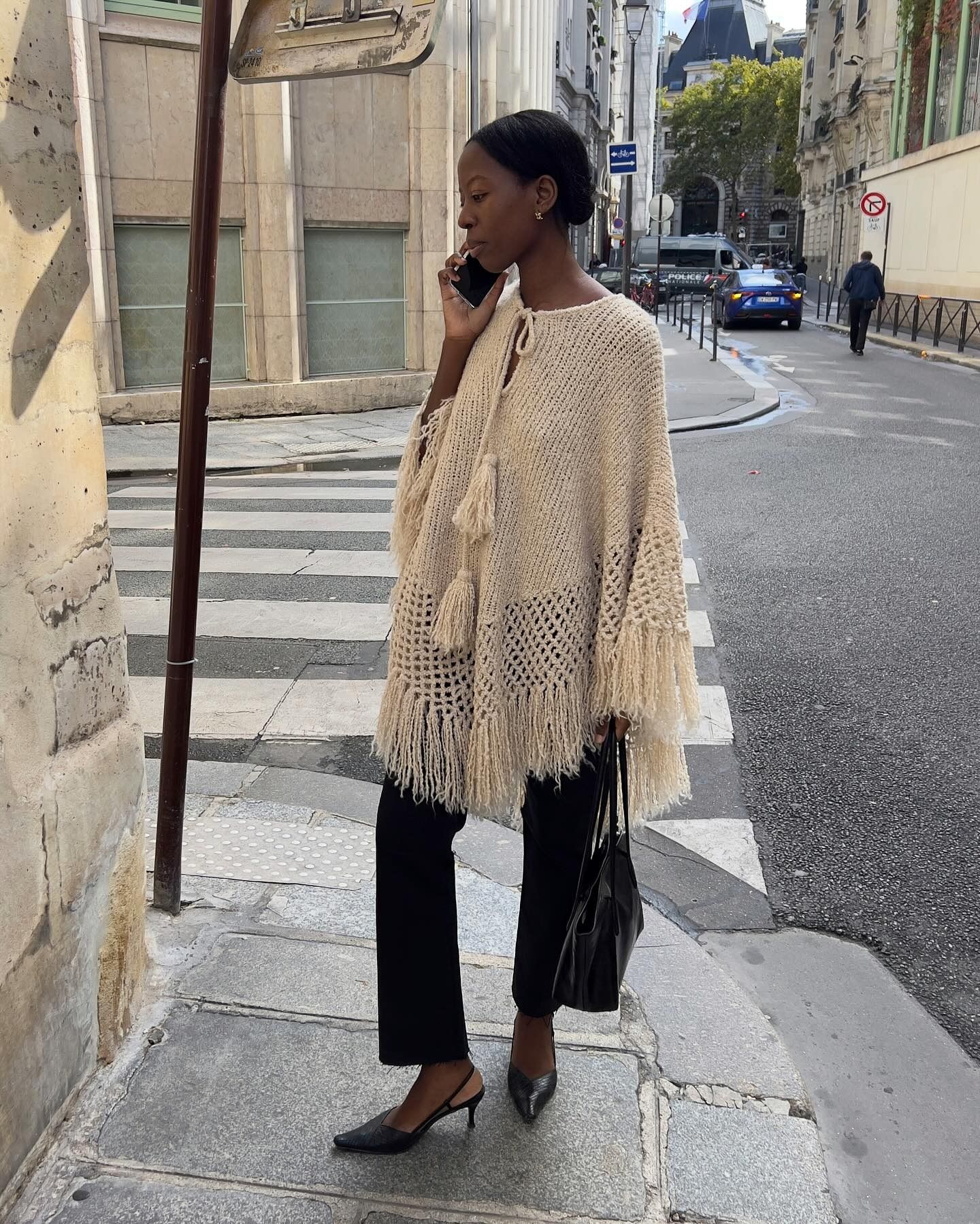 Fashion person Sylvie Mus wears the French Women Poncho Trend.