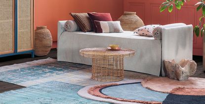 grey sofa with red and white patterned pillows